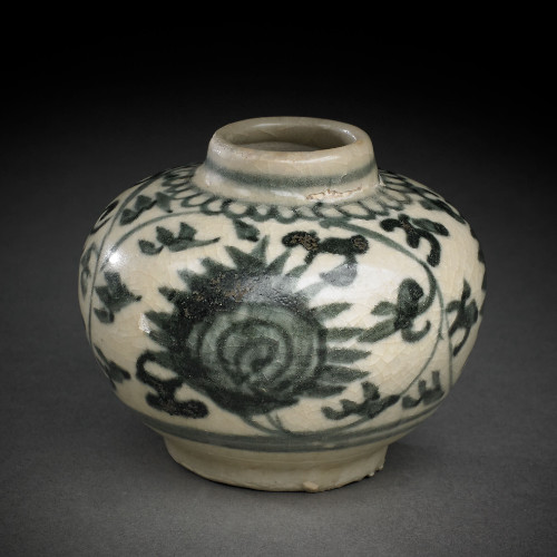 A small, rounded ceramic jar with a crackled off-white glaze, decorated with dark painted leafy vines and a large, multi-petaled flower with a swirling center.