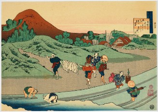 figures washing riverside with mountain in distance.