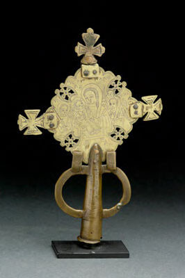 Central cross, with smaller crosses  attached as finials, projecting from each arm. Bracket on lower arm attached to shaft.