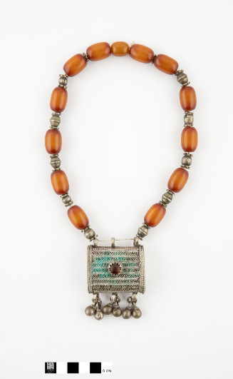 Amber bead necklace with rectangular porte Koran pendant.