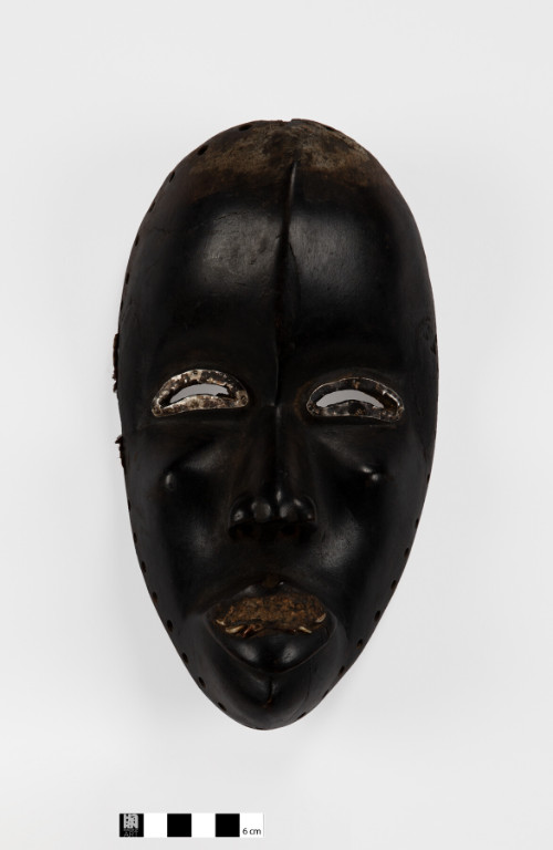 Dan style; inset teeth; white metal eyes; resin in the mouth; pigment; darkened surface; encrustation