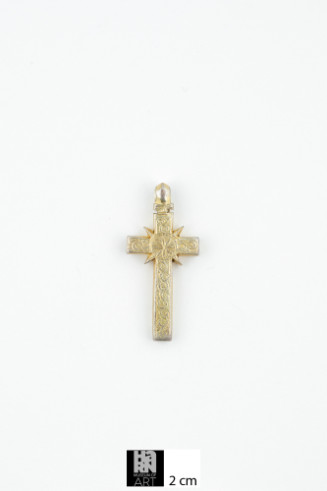 Gilded silver pendant in the form of a Latin cross with a ring for suspension; on either side of the shorter arms are two sharp edged triangular shapes; surface has an intricately incised design with a central floral pattern enclosed in a circle, and a vine like pattern on the arms; the arms also have an incised linear border; on the reverse, there is an inscription across the shorter arm