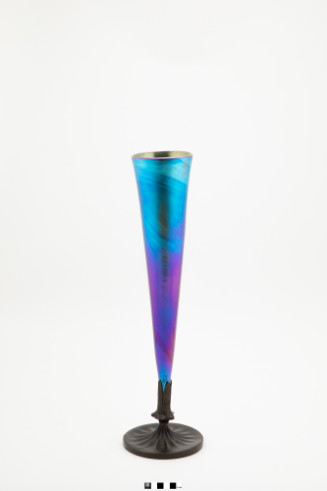 Blue Favrile glass stemmed vase in a trumped shape with bronze stem