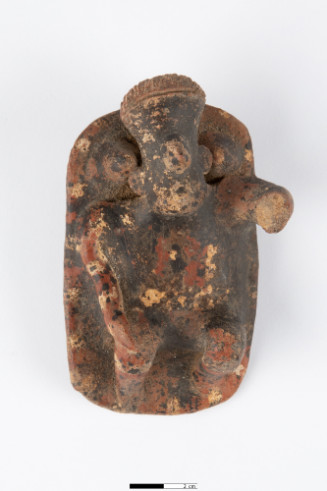 Reclining on platform raised at top end with two conical pegs; legs bent at knees; right hand on right knee; left arm raised, broken off; wide chest; large nose and chin; braces on either side of head; coiffure decorated with incised lines