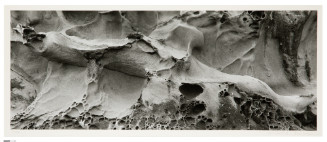 Abstract-looking image that could be close-up or at a far distance of swirling curves, topographies, and textures.