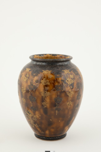 Ovoid vase with mottled brown glaze and enameled floral design.