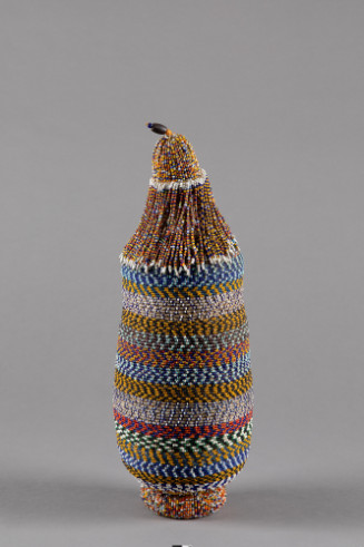 Cylindrical stoppered vessel covered with glass beads in horizontal bands, stopper has beaded fringe.