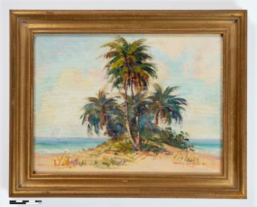 A gold-framed painting of a cluster of green palm trees on a sandy beach dune. A blue ocean, distant sailboat, and pale cloudy sky are visible behind them.